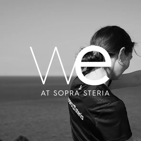 women sitting on a bed using a laptop