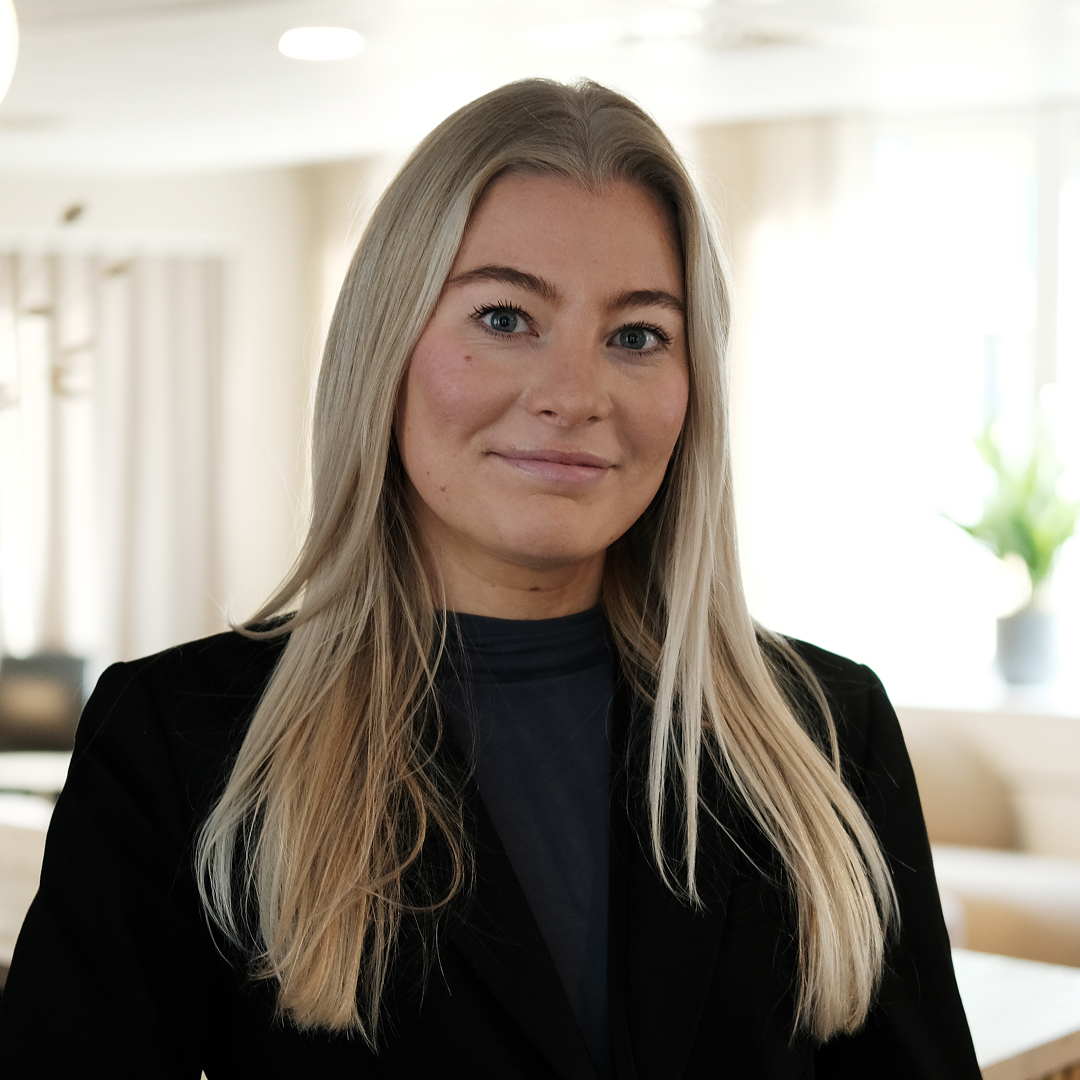 women sitting on a bed using a laptop
