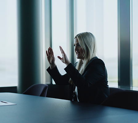 women sitting on a bed using a laptop