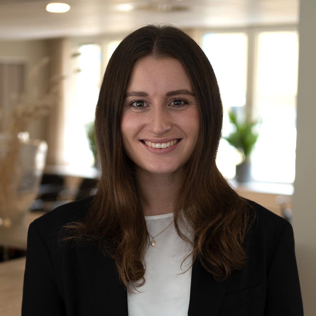 women sitting on a bed using a laptop