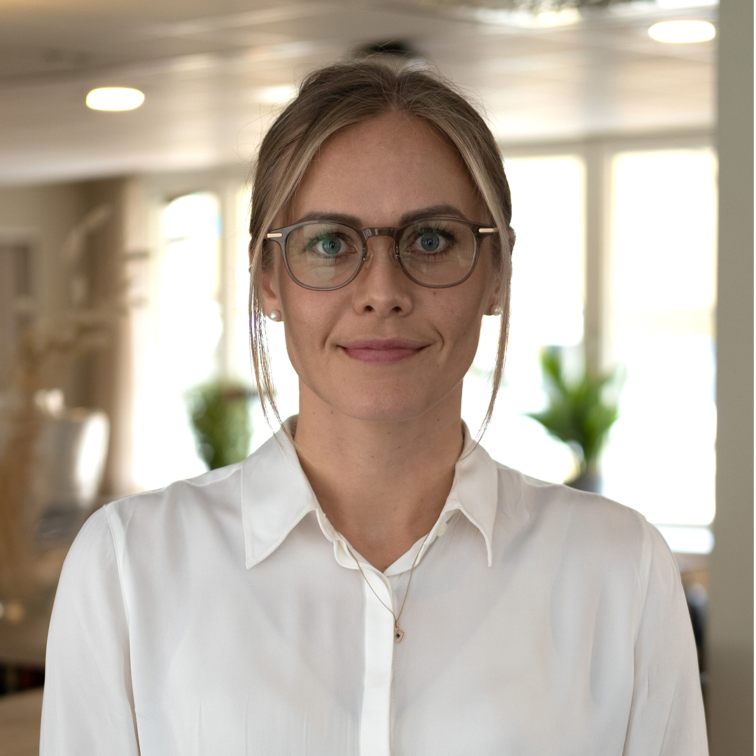 women sitting on a bed using a laptop