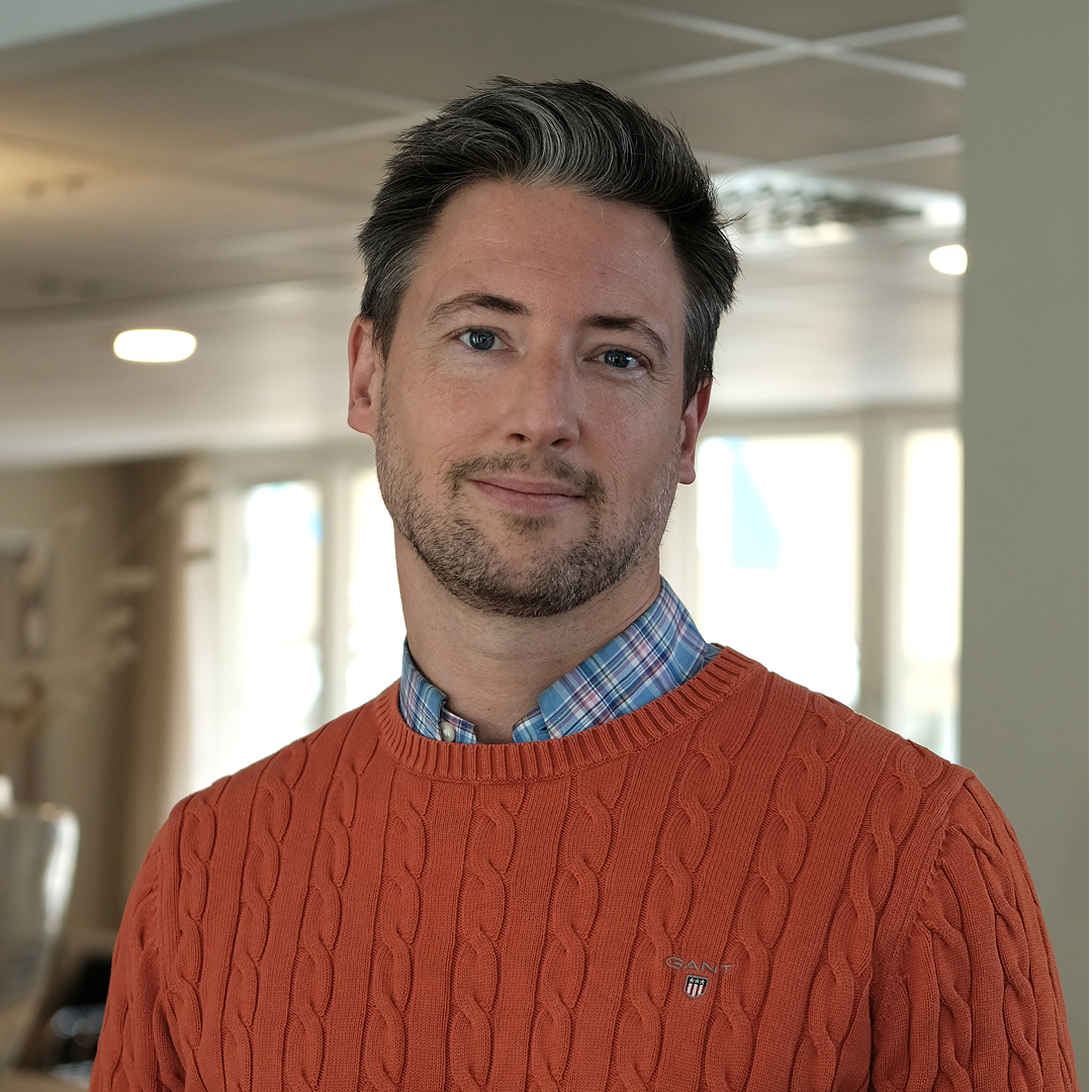 women sitting on a bed using a laptop