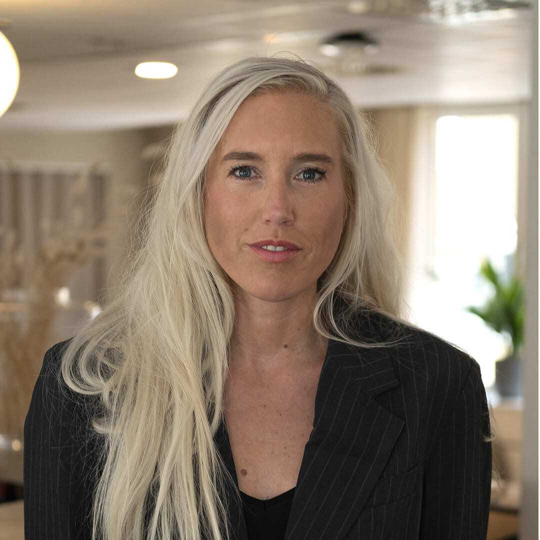 women sitting on a bed using a laptop