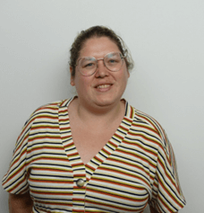 women sitting on a bed using a laptop