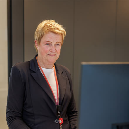 women sitting on a bed using a laptop