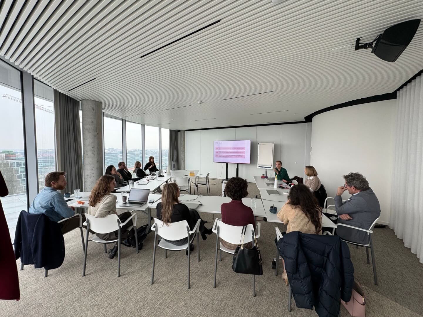 women sitting on a bed using a laptop