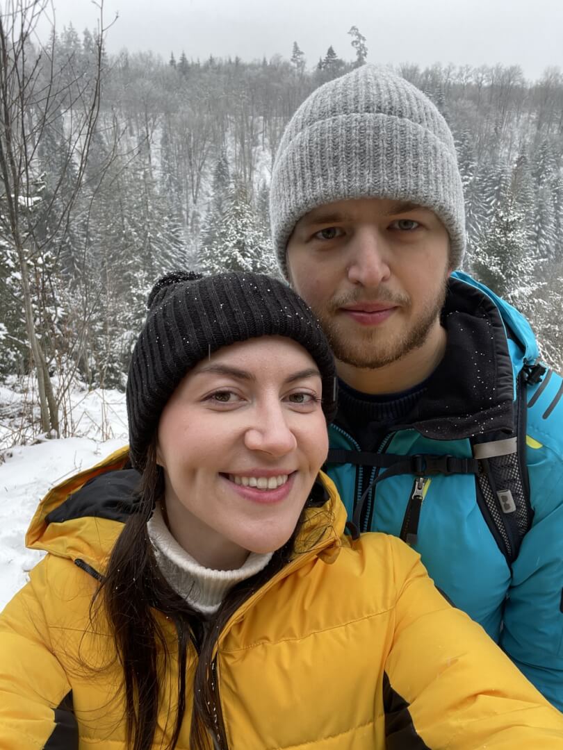 women sitting on a bed using a laptop