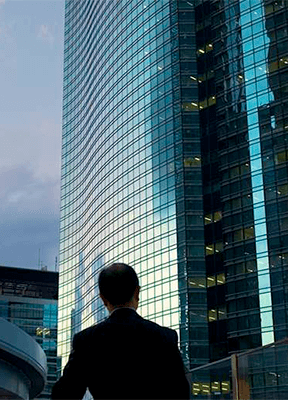 women sitting on a bed using a laptop