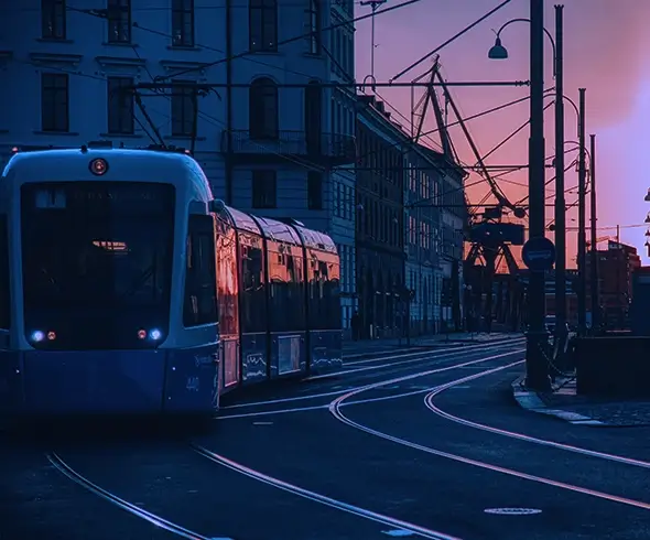 women sitting on a bed using a laptop