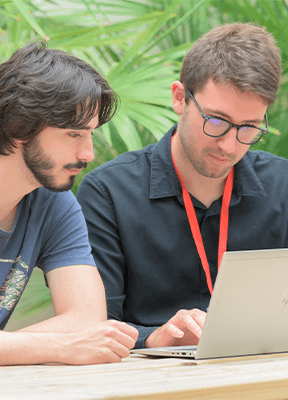 two young men working at their computers