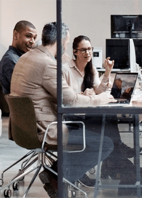 women sitting on a bed using a laptop