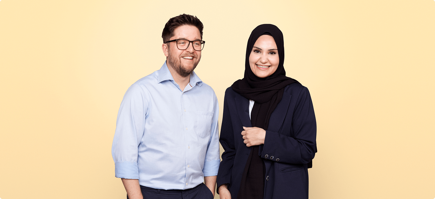Smiling store co-owners, such as opticians or sales assistants, who have entered into a partnership.