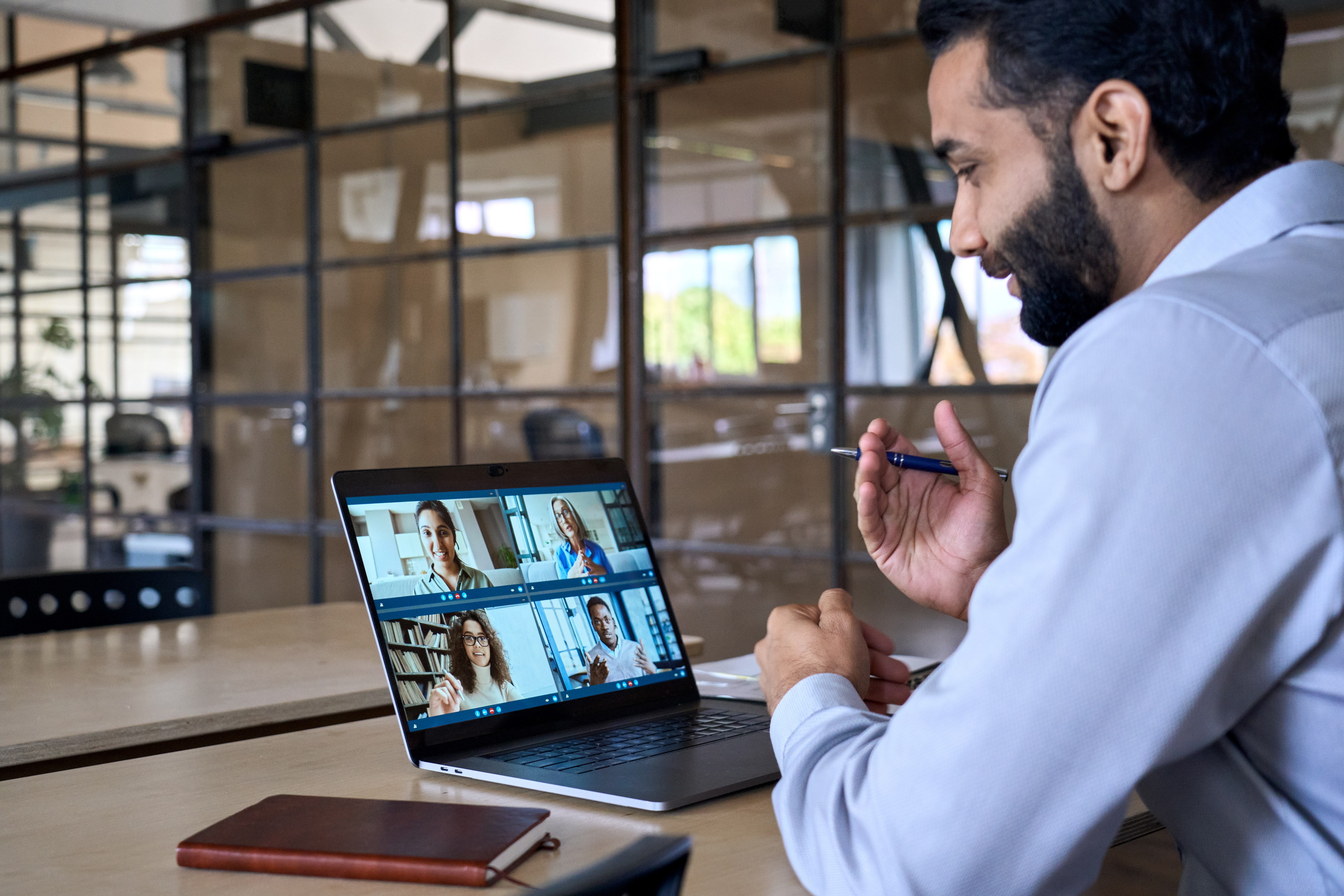 Man in an office on a zoom call