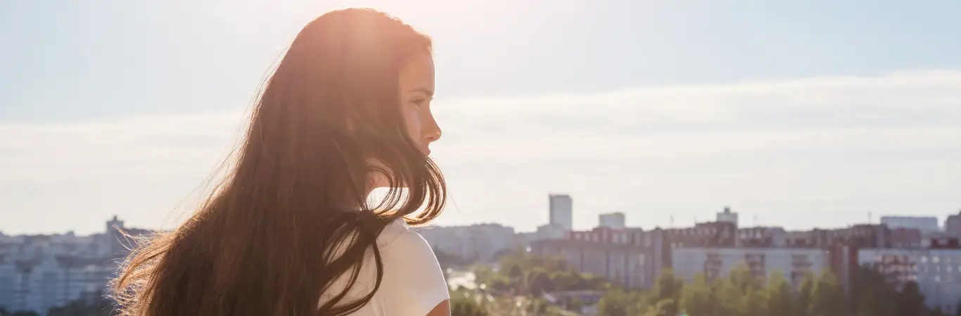 A woman looking into an urban horizon. 