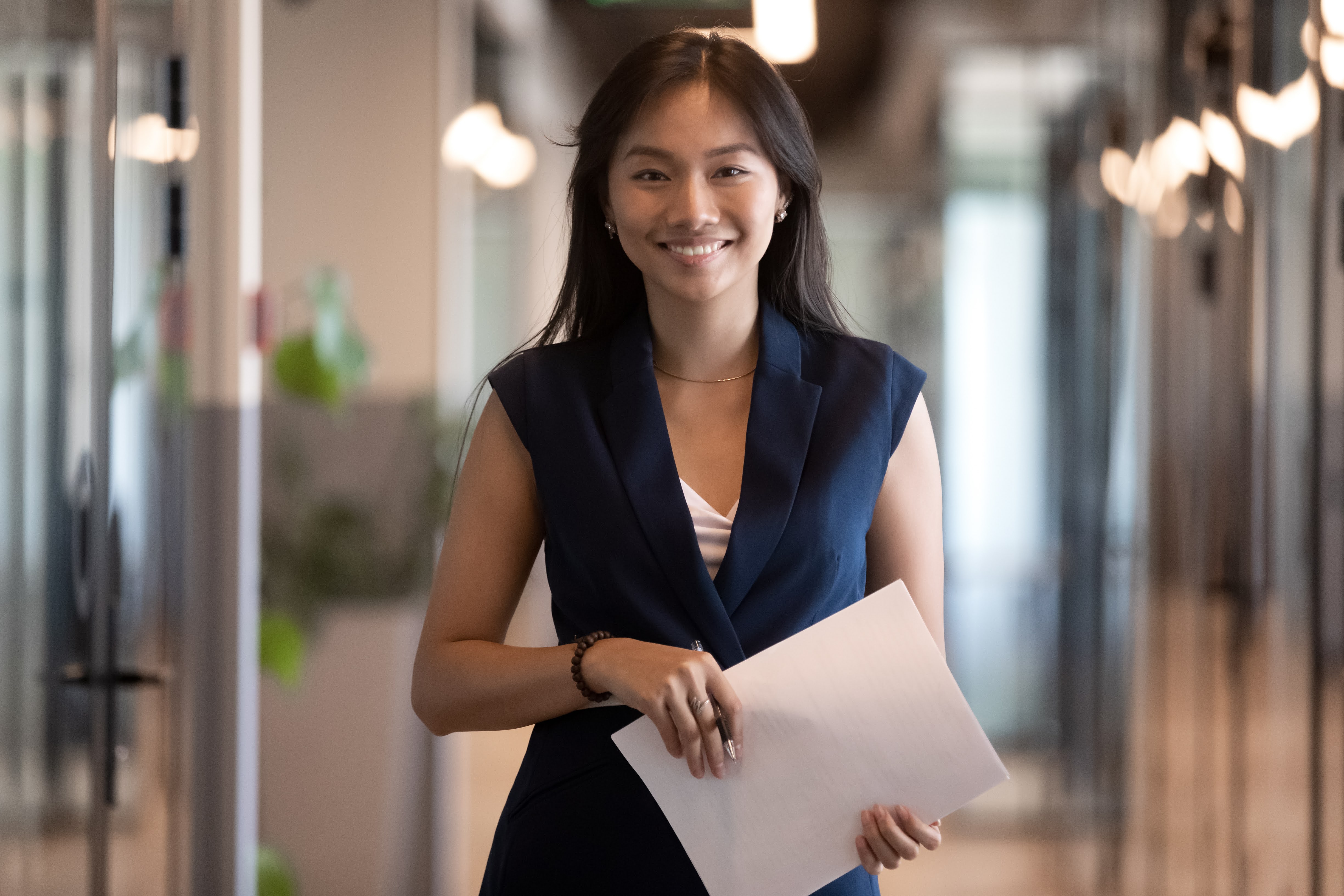 Woman holding some paper in an office