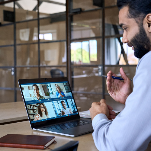 Man in an office on a zoom call. 