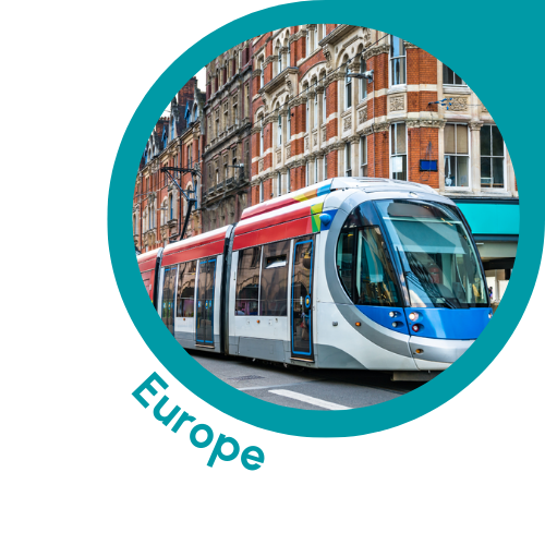 A modern tram is seen traveling through a European city, surrounded by historic buildings with intricate architectural details. The tram is white with blue and red accents, and it is moving along a street lined with older brick structures. The image is framed by a teal circle, with the word "Europe" written below in teal text, emphasizing the European context of the scene.