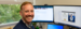 Westgate corporate employee smiling at his desk.