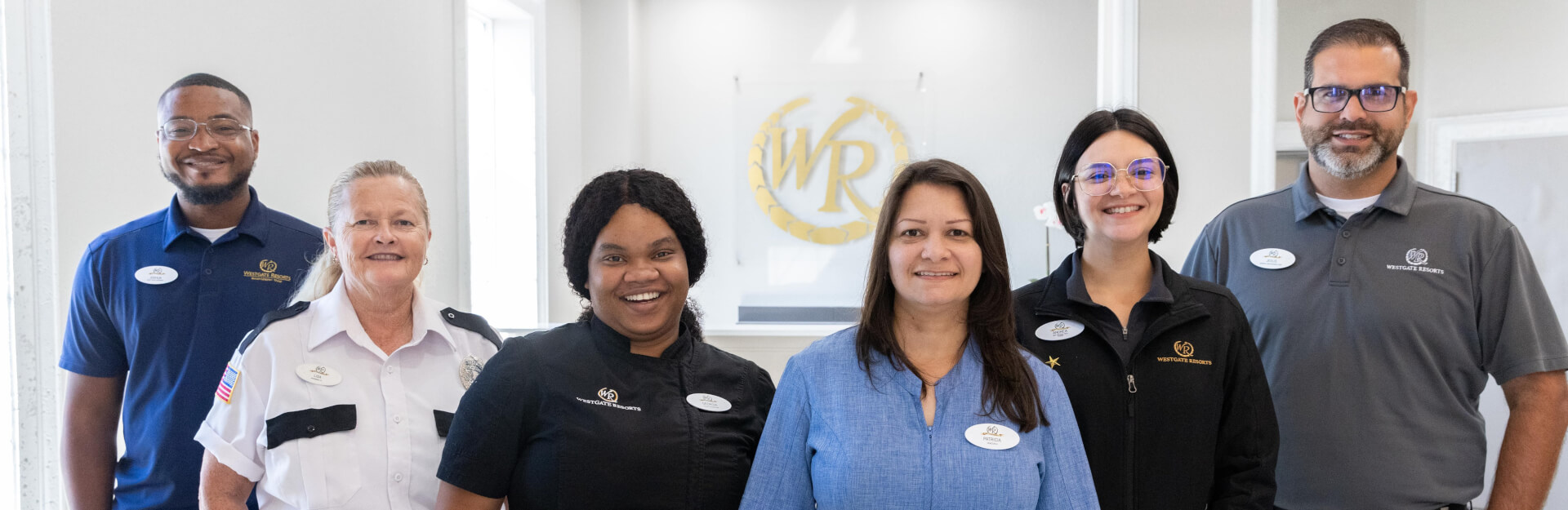Westgate employees stood in a line smiling in different uniforms