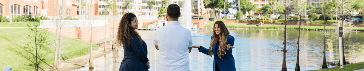 Westgate Sales Team in front of a body of water, talking, smiling