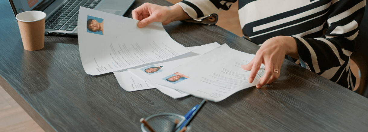 Recruiter sorting through pile of Resumes