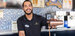 Smiling bartender pouring a drink