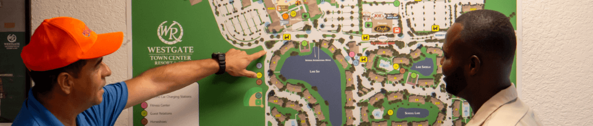 Westgate Team Members pointing at a Resort Map