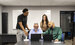 The Westgate Call Center team sat around a table looking at a laptop 