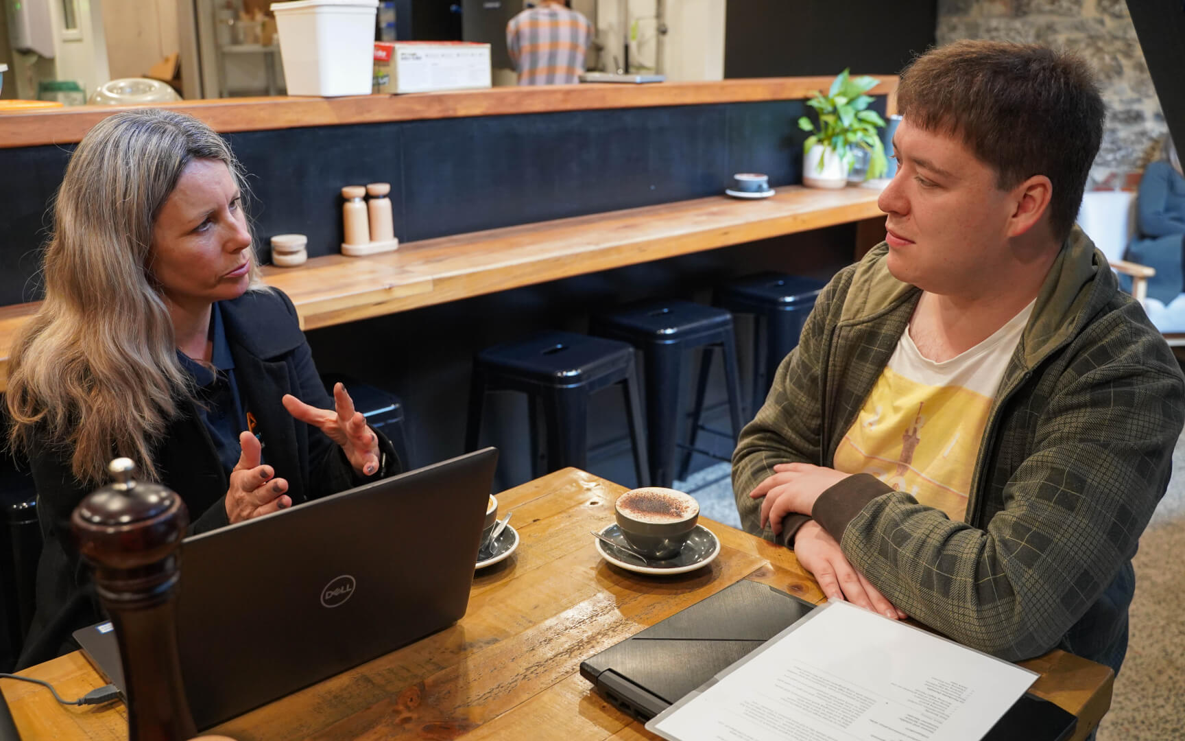 a circular overlay with two men walking down a street with text