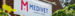 Medivet logo and "Always There" slogan on a sign at the side of a building.
