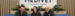 Medivet team sat smiling in front of a Medivet sign