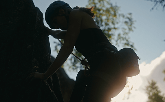 A woman climbing a mountain