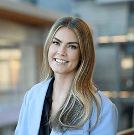 A blonde woman smiling to the camera