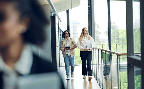 Two colleagues walking and laughing
