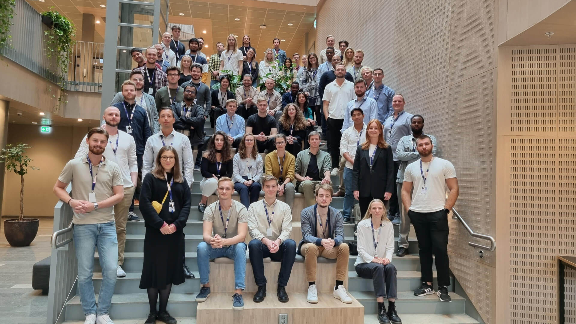 Employees sitting in the staircase looking into the camera