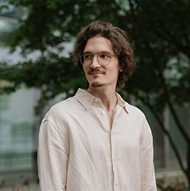 A man with brown hair an glasses