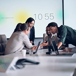 Five colleagues looking at a phone, laughing