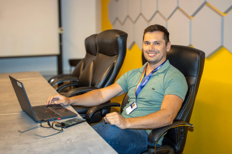 Man working on laptop and smiling