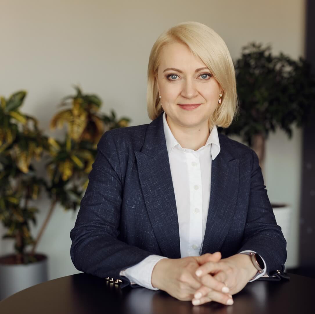 A woman with blonde hair looking into the camera