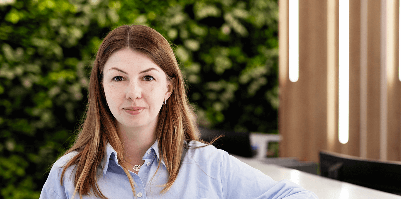 A woman with brown hair looking into the camera