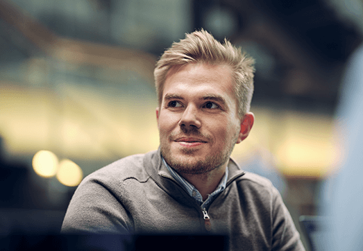 A man with blonde hair smiling