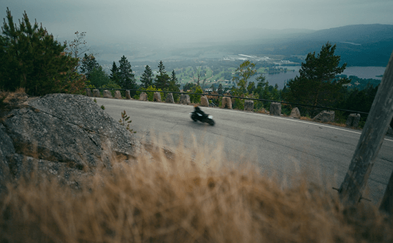 A woman riding her motorbike in the mountains