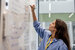 Woman writing on white board