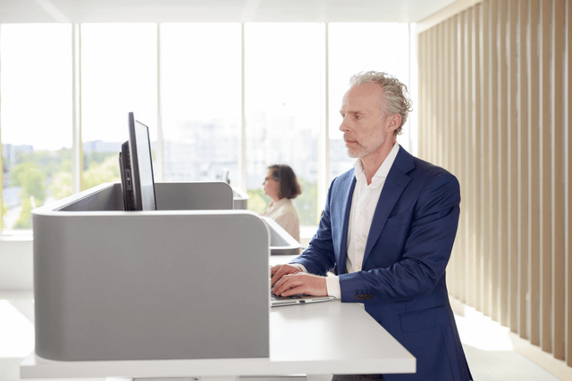 Men standing in front of the computer