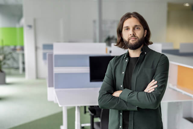 Men standing in front of the computer