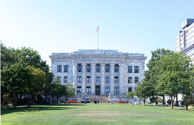 Main building of Harvard’s Longwood campus, home to the Medical and Dental Schools, viewed from the central lawn on a clear day.