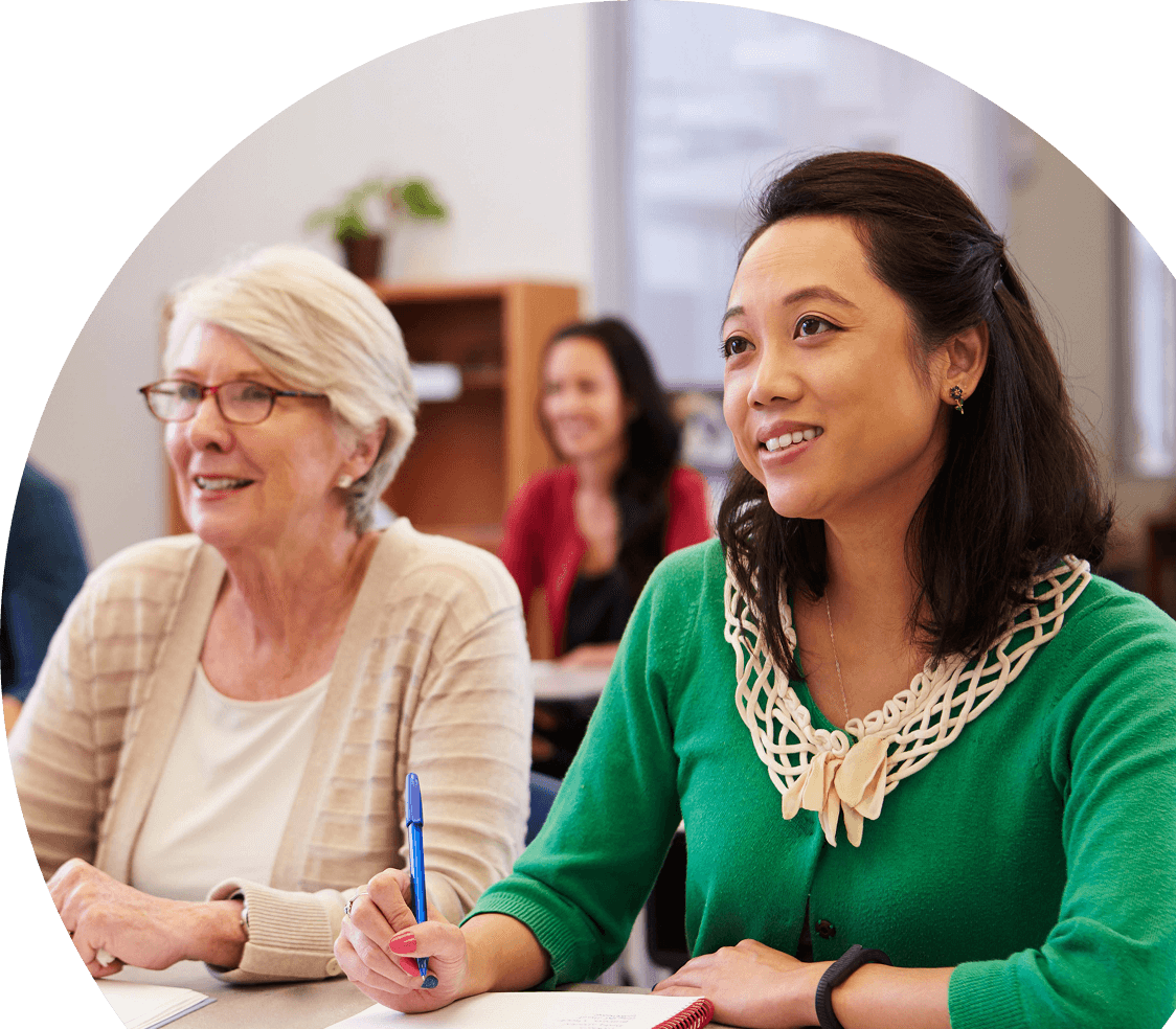 An image of two woman sitting in a class together