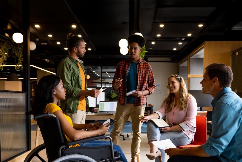 An image of four people working together