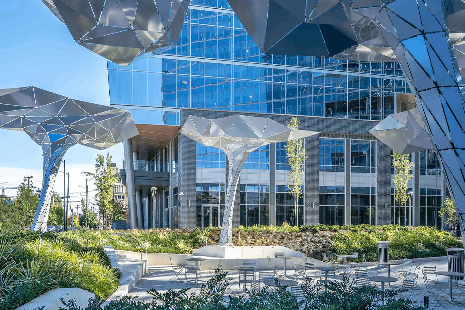 Two people working together on laptops in an office.