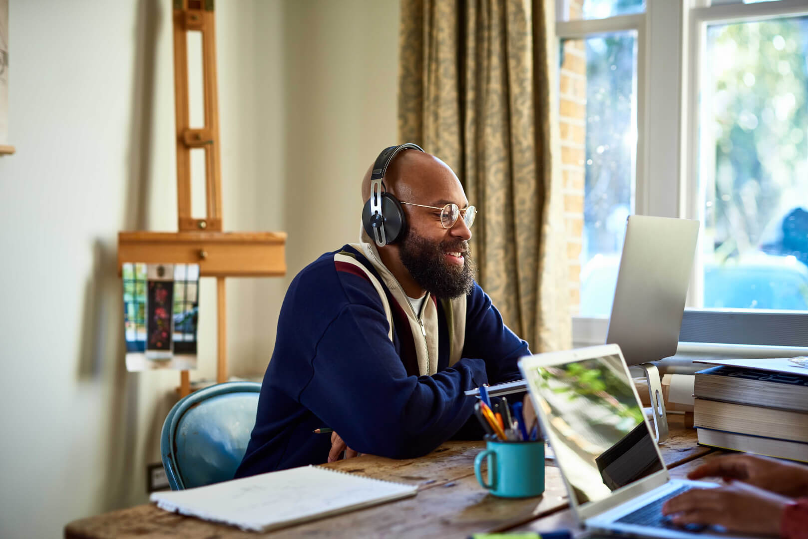 Man smiling while working on a video call from home.